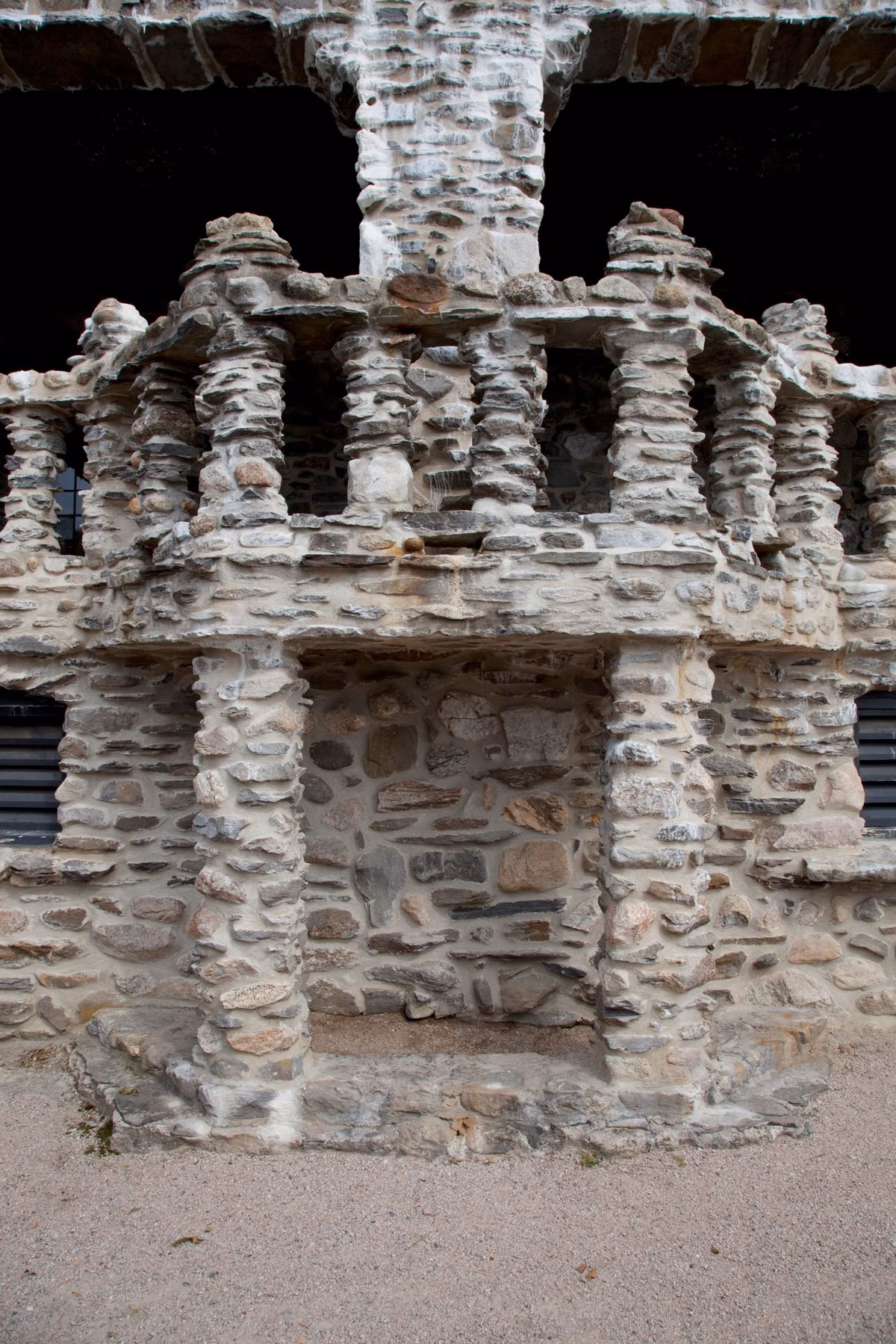 Close view of a fieldstone tower with stone parapets