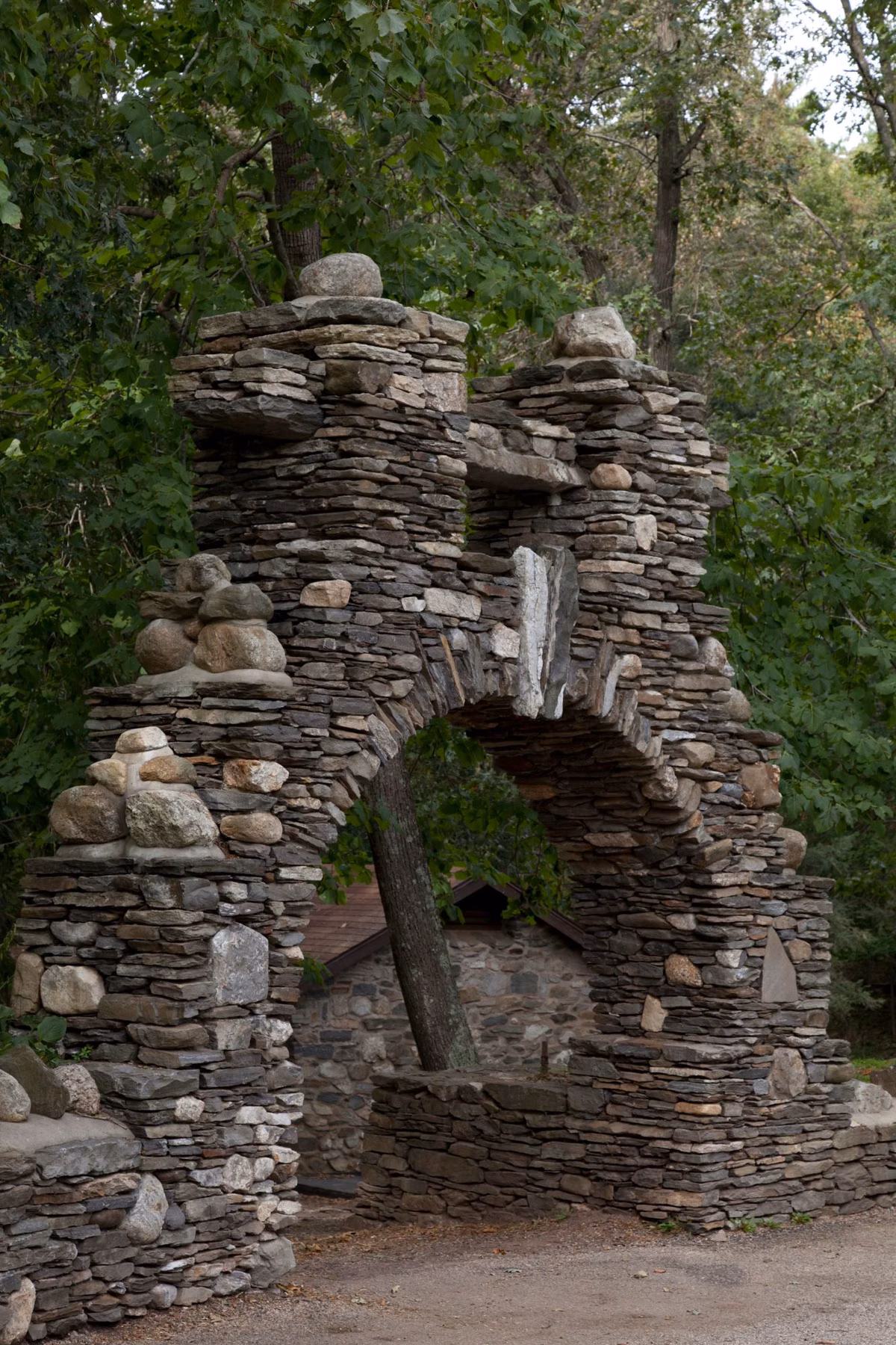 Narrow fieldstone arch gate in the woods